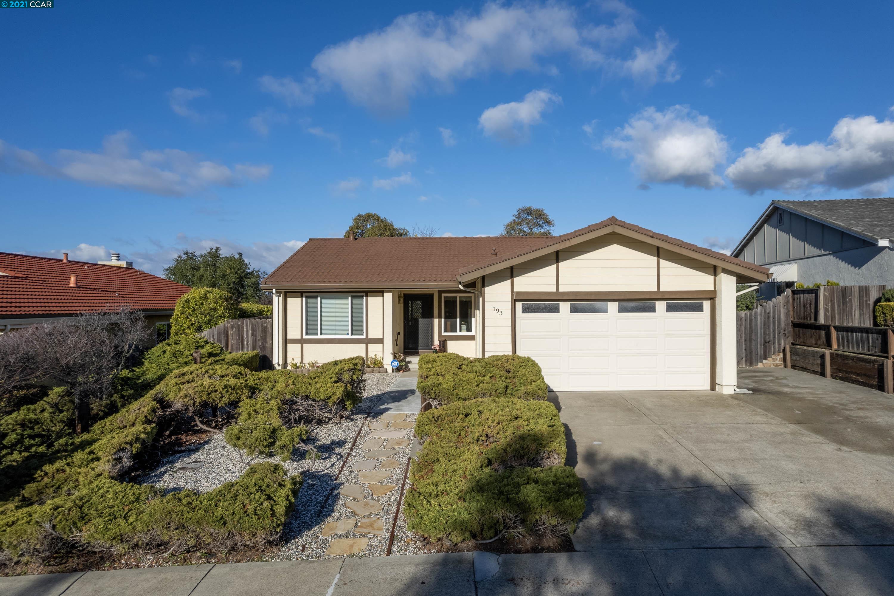 a front view of a house with a yard and garage