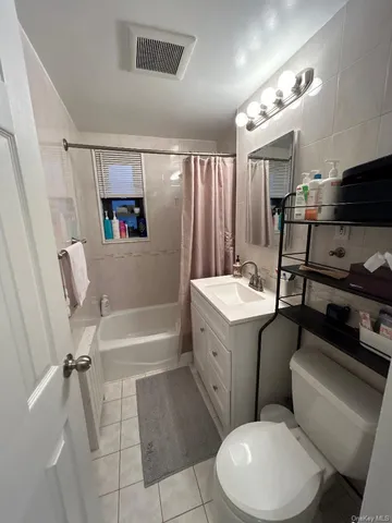 a bathroom with a sink mirror vanity and toilet