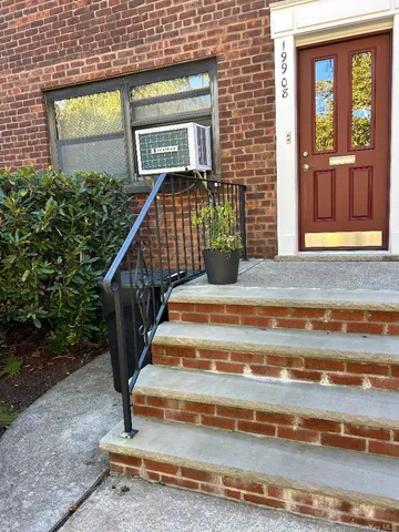 a view of entryway with wooden floor and a front door