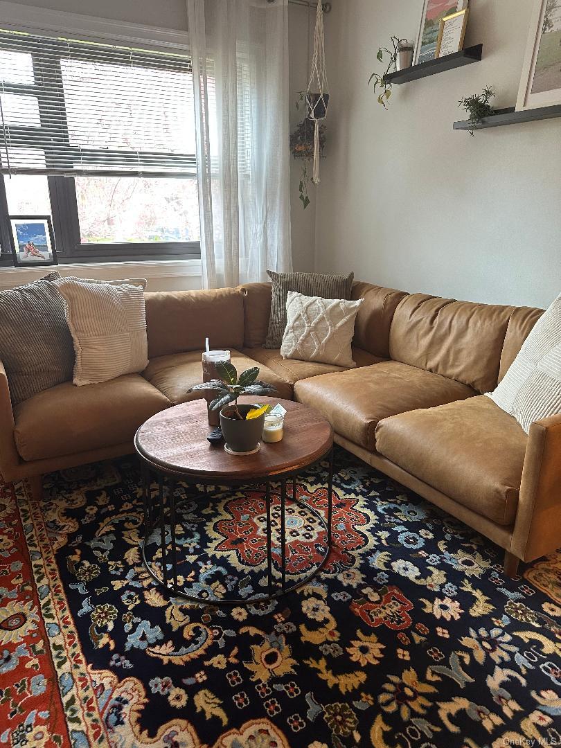199-08 21st Avenue, Unit 1327 Queens, NY 11357 - Photo 4 of 21 a living room with furniture and a window