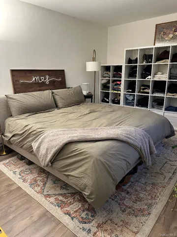a bedroom with a bed and a mirror