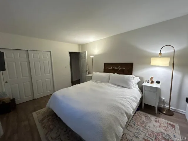 a bedroom with a bed and a mirror