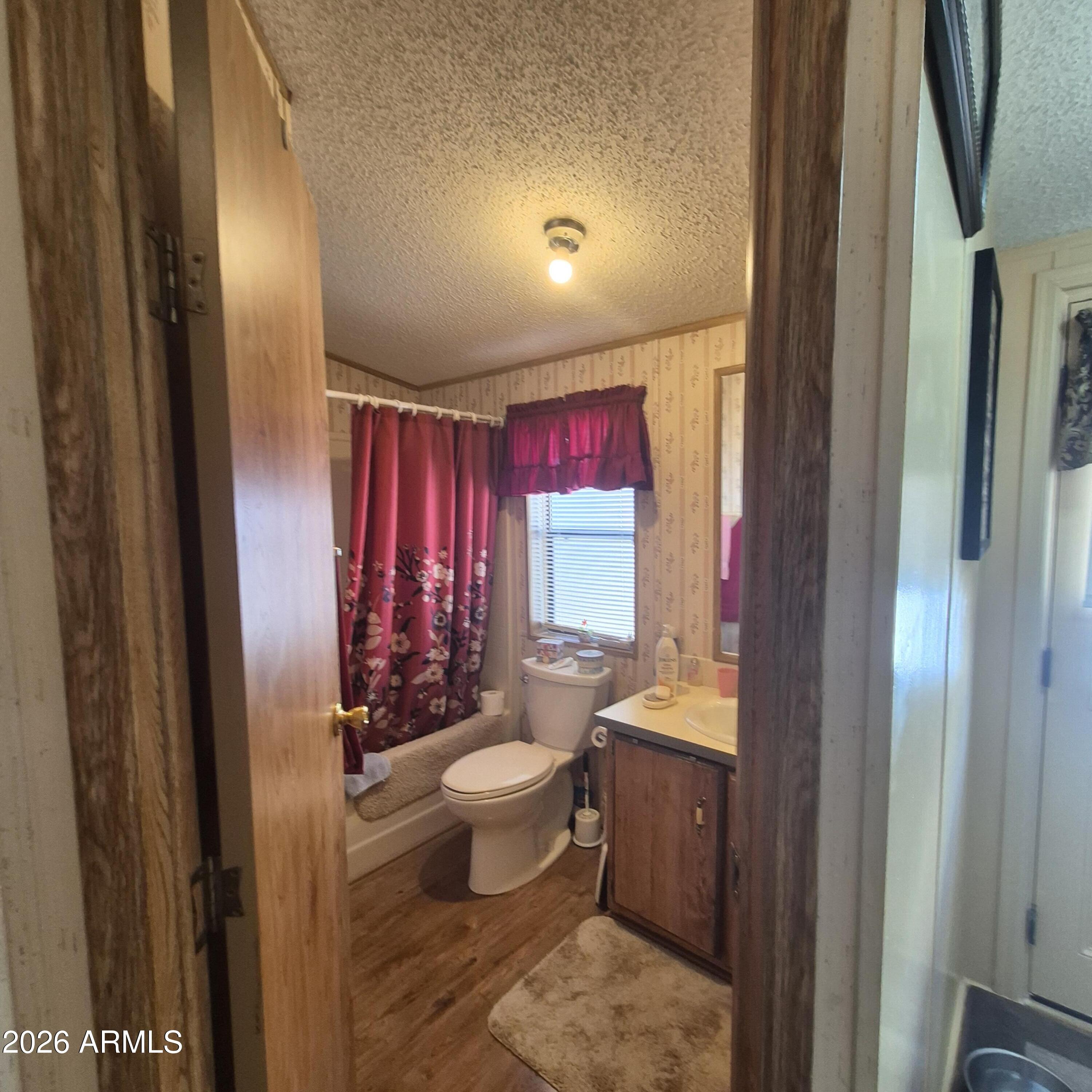 1980 South Hilton Road Apache Junction, AZ 85119 - Photo 17 of 42 a bathroom with a toilet sink and mirror