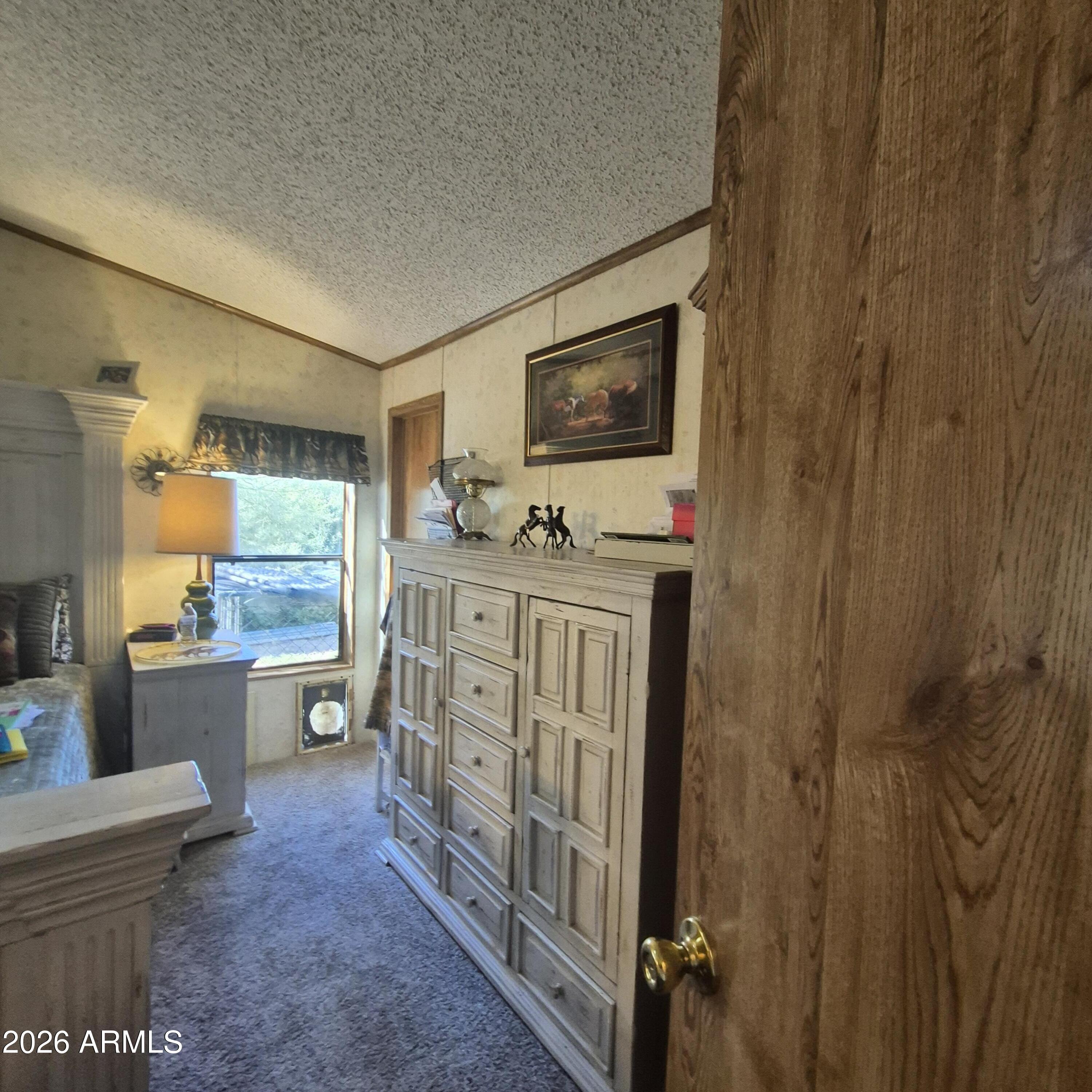 1980 South Hilton Road Apache Junction, AZ 85119 - Photo 19 of 42 a room with a wooden floor and furniture