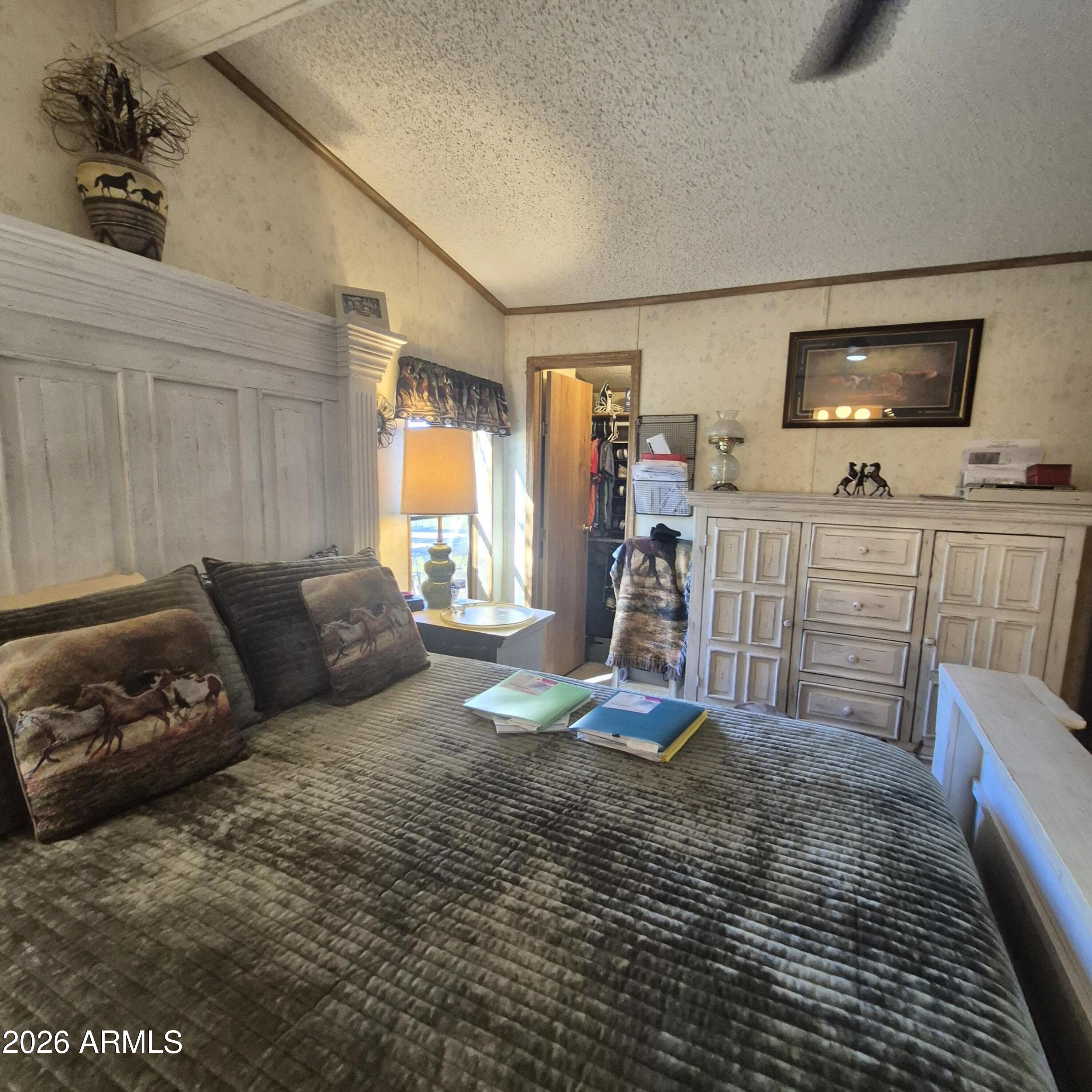 1980 South Hilton Road Apache Junction, AZ 85119 - Photo 21 of 42 a living room with furniture a flat screen tv and a refrigerator