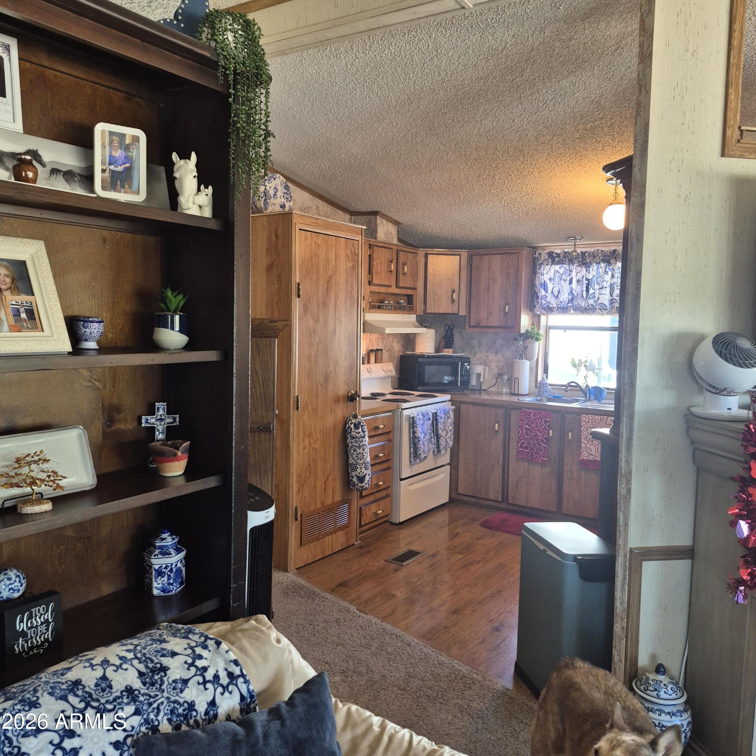 1980 South Hilton Road Apache Junction, AZ 85119 - Photo 7 of 42 a kitchen with stainless steel appliances granite countertop a refrigerator sink and stove