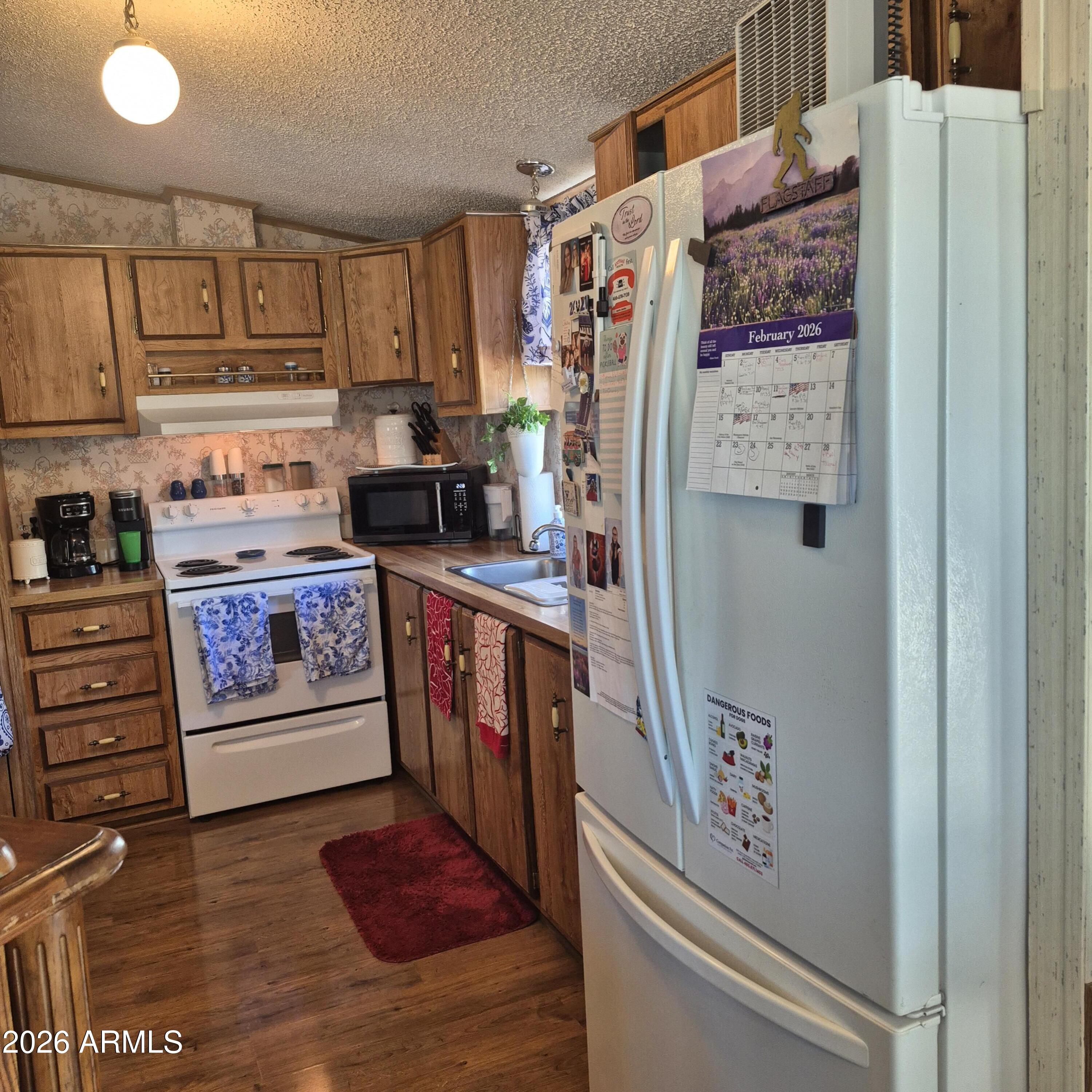 1980 South Hilton Road Apache Junction, AZ 85119 - Photo 8 of 42 a kitchen with stainless steel appliances granite countertop a refrigerator and a stove