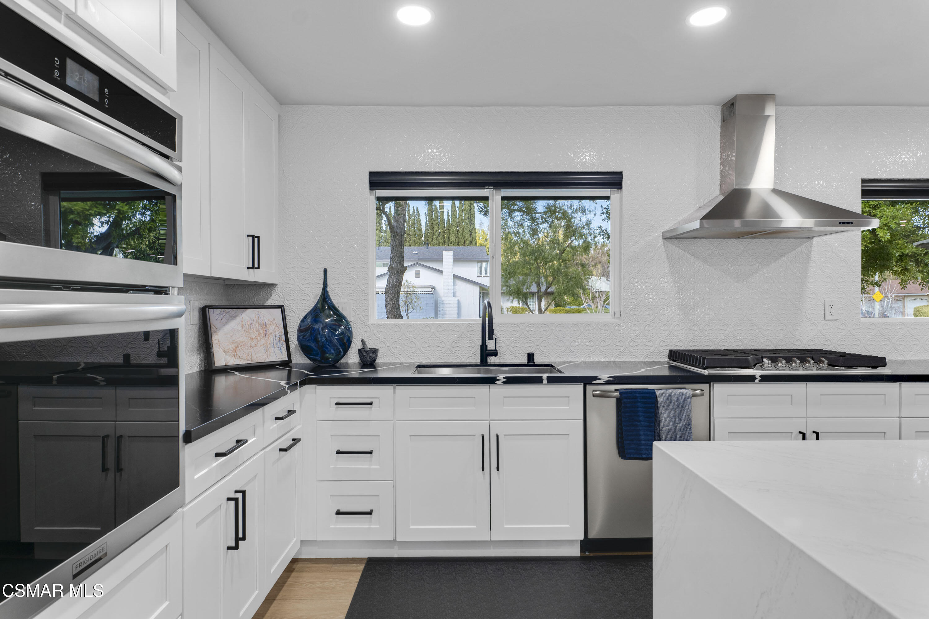 19120 Salt Lake Place Porter Ranch, CA 91326 - Photo 12 of 47 a kitchen with white cabinets and appliances