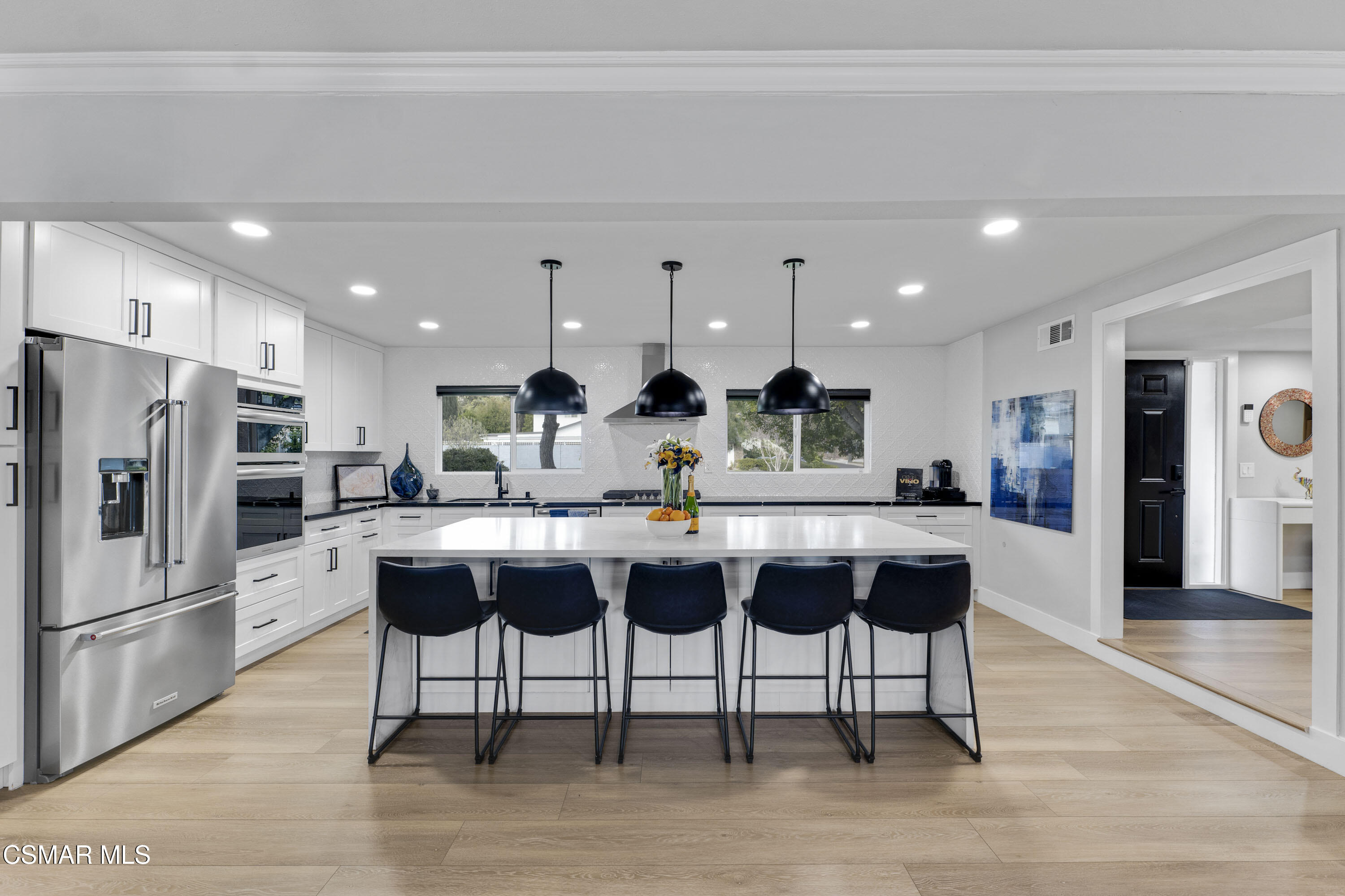 19120 Salt Lake Place Porter Ranch, CA 91326 - Photo 13 of 47 a kitchen with stainless steel appliances kitchen island granite countertop a refrigerator and a sink