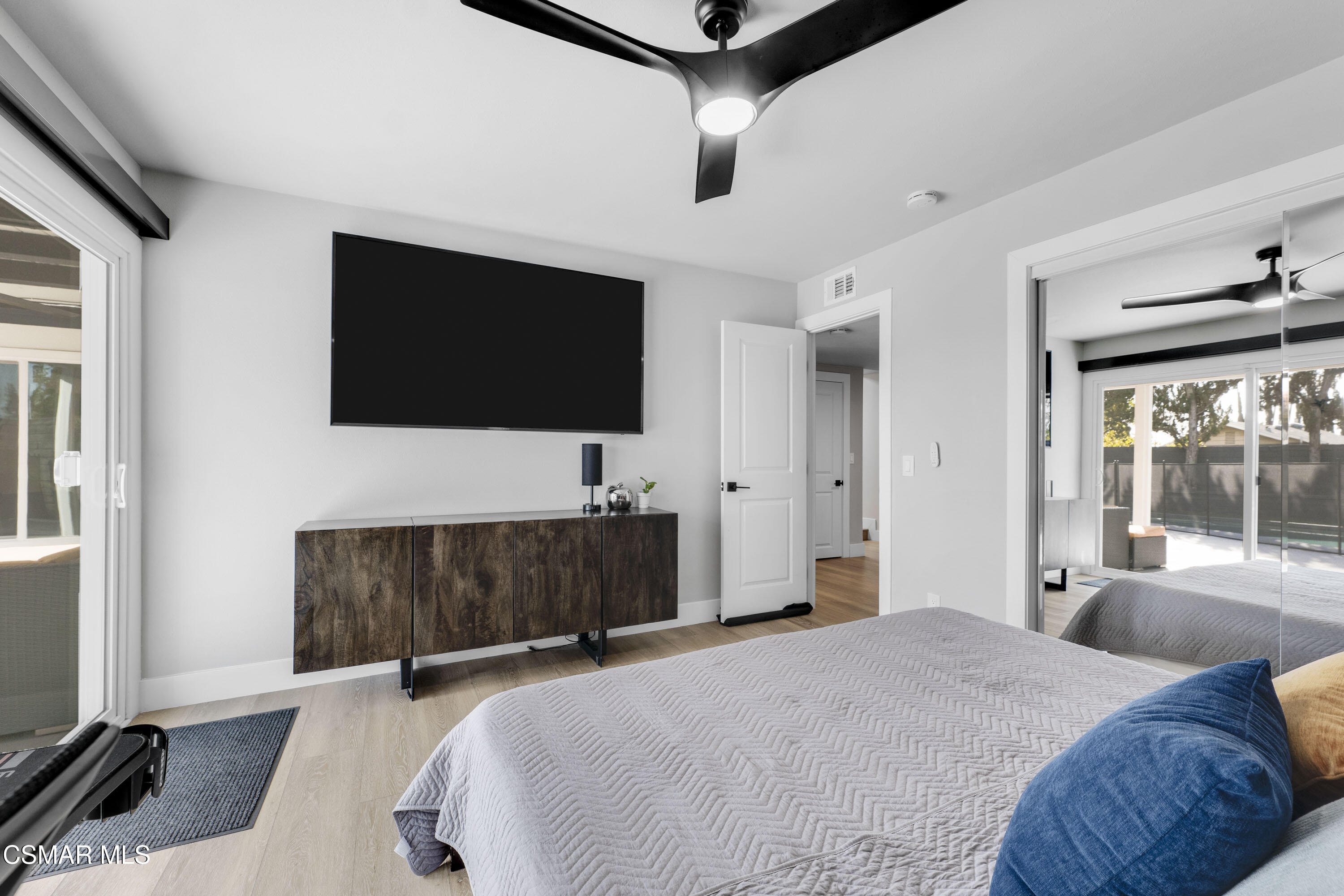 19120 Salt Lake Place Porter Ranch, CA 91326 - Photo 20 of 47 a bedroom with a bed and a flat tv screen on wall