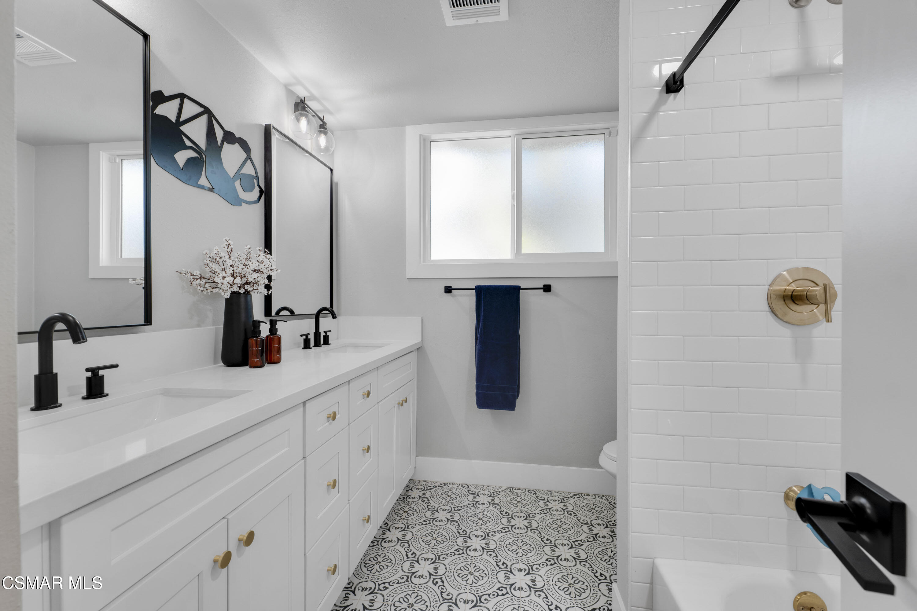 19120 Salt Lake Place Porter Ranch, CA 91326 - Photo 34 of 47 a bathroom with a double vanity sink and mirror