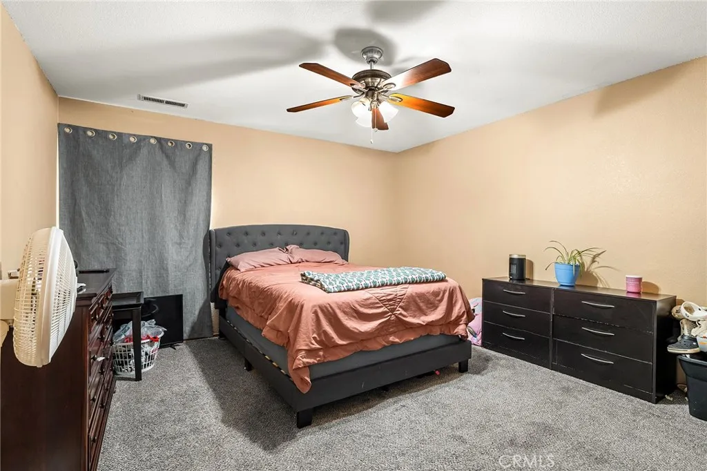 631 North Street, Unit 631 Corning, CA 96021 - Photo 15 of 39 a spacious bedroom with a bed and a chandelier