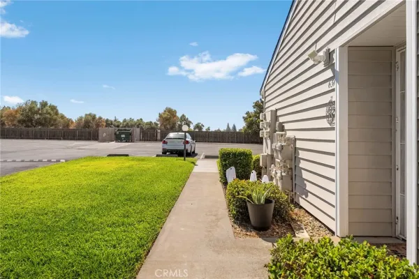 a view of a house with a yard and large tree