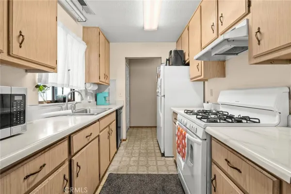 a kitchen with stainless steel appliances granite countertop a stove and a sink