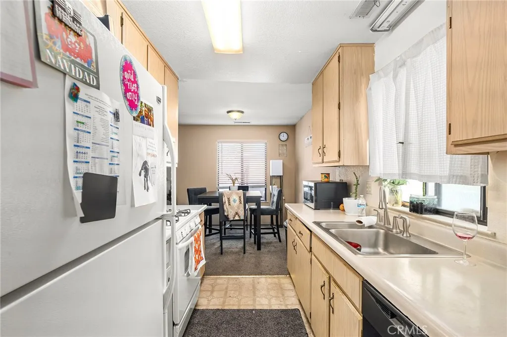 631 North Street, Unit 631 Corning, CA 96021 - Photo 6 of 39 a kitchen that has a lot of cabinets a sink and a stove in it