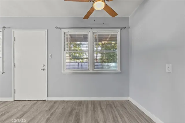 a view of a room with wooden floor and window