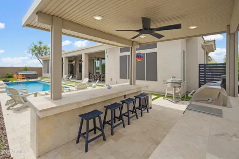 a open kitchen with stainless steel appliances kitchen island a stove a refrigerator with white cabinets and wooden floor