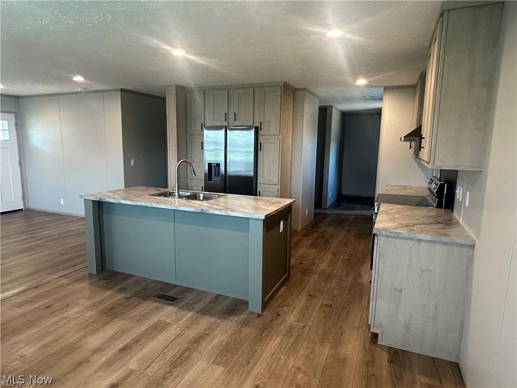 252 Front Street Philo, OH 43771 - Photo 5 of 17 Kitchen with light countertops, stainless steel appliances, a center island with sink, dark wood-style flooring, and recessed lighting