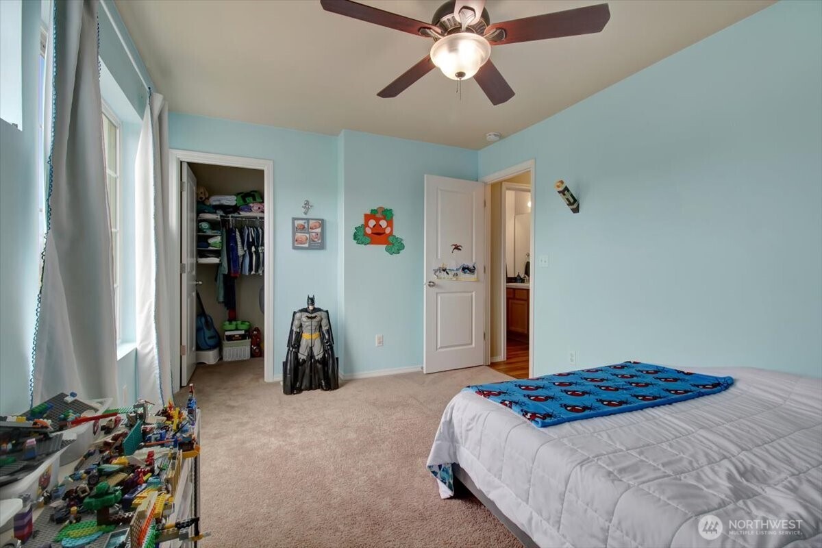 5488 Buckhorn Way Mount Vernon, WA 98273 - Photo 35 of 40 a bedroom with a bed and a chandelier