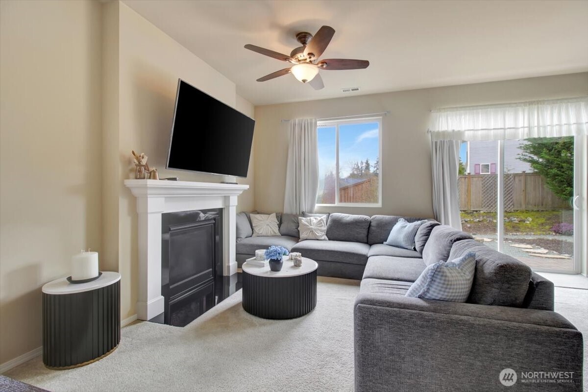 5488 Buckhorn Way Mount Vernon, WA 98273 - Photo 6 of 40 a living room with furniture a fireplace and a flat screen tv