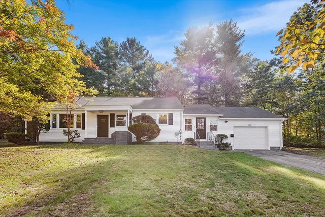 a front view of house with yard and green space