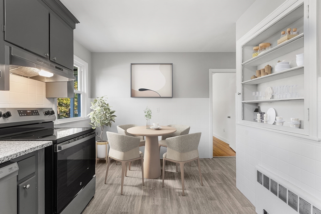 222 Forge Village Road Groton, MA 01450 - Photo 4 of 12 a kitchen with a table chairs stove and cabinets