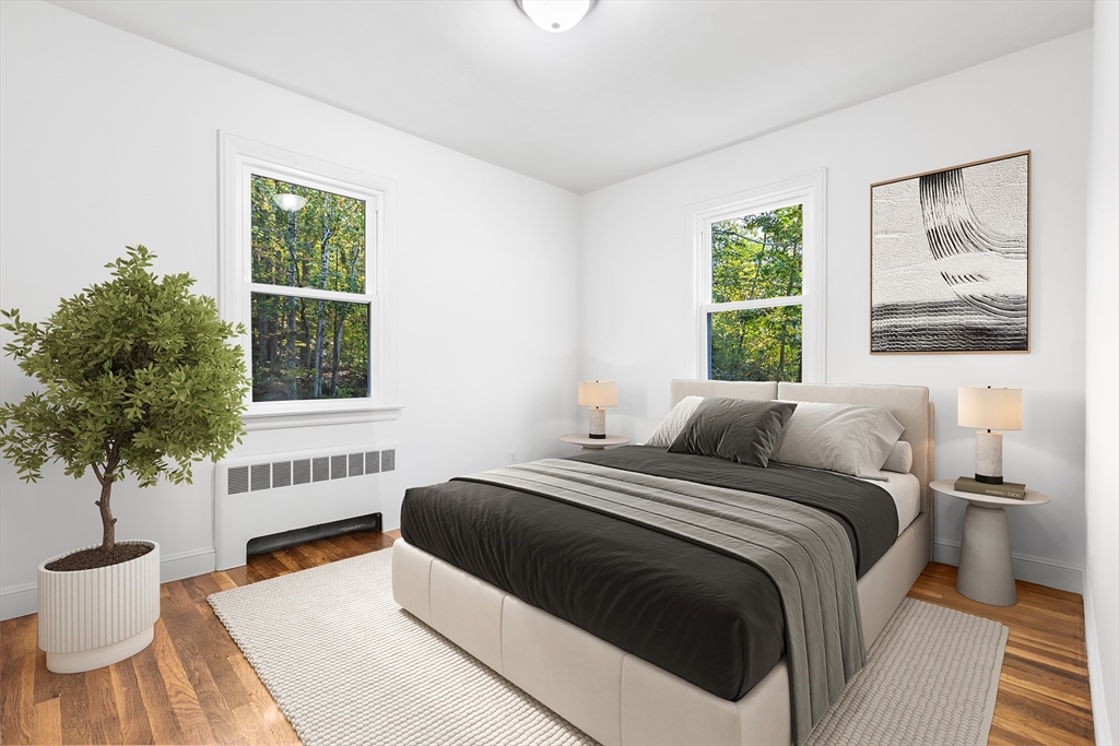 222 Forge Village Road Groton, MA 01450 - Photo 6 of 12 a bedroom with a bed and a potted plant