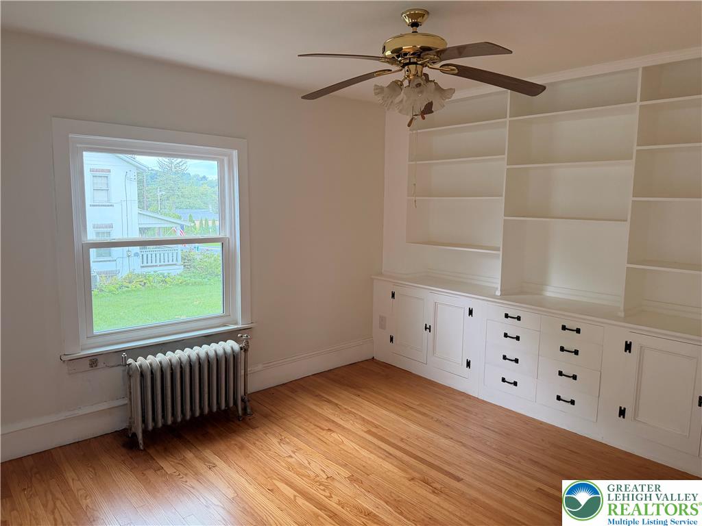 5111 Vera Cruz Road Emmaus, PA 18049 - Photo 14 of 44 Rich hardwood floors and extensive custom built-in shelving define this versatile room.