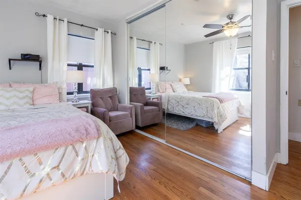 a spacious bedroom with a bed and a chandelier