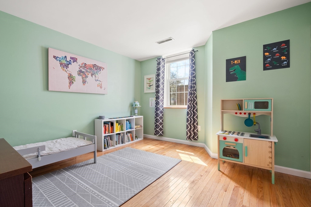 35 Eldridge Road, Unit 202 Boston, MA 02130 - Photo 15 of 31 a bedroom with a bed and a bookshelf