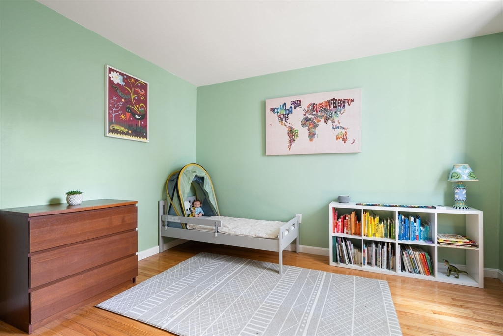 35 Eldridge Road, Unit 202 Boston, MA 02130 - Photo 16 of 31 a bedroom with a bed and a bookshelf