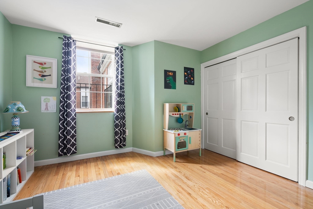 35 Eldridge Road, Unit 202 Boston, MA 02130 - Photo 17 of 31 a view of empty room with wooden floor and fan