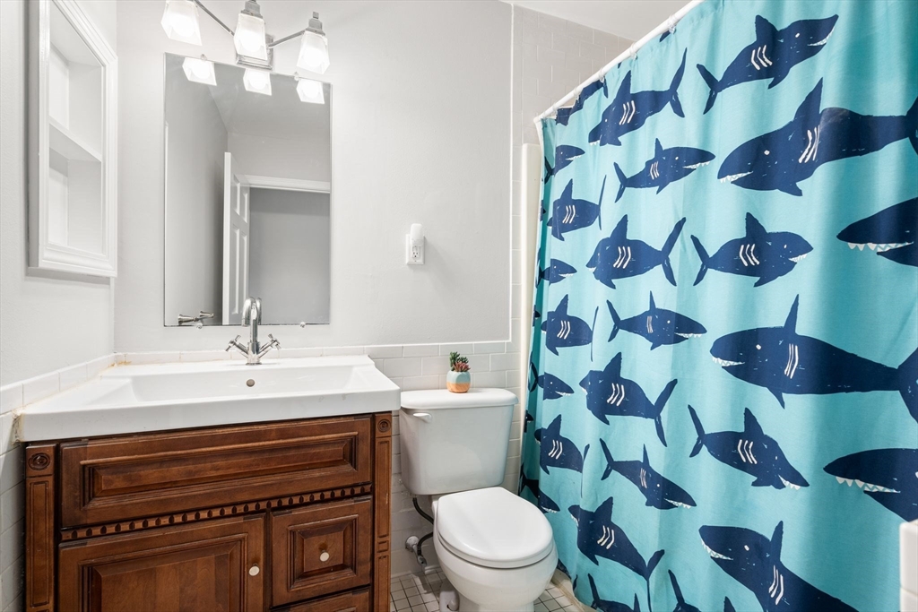 35 Eldridge Road, Unit 202 Boston, MA 02130 - Photo 19 of 31 a bathroom with a sink a toilet and a mirror