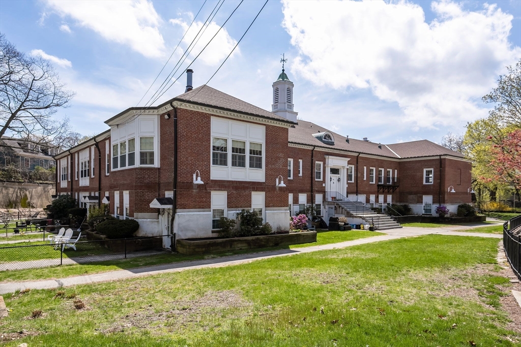 35 Eldridge Road, Unit 202 Boston, MA 02130 - Photo 2 of 31 a front view of building with yard and lake view