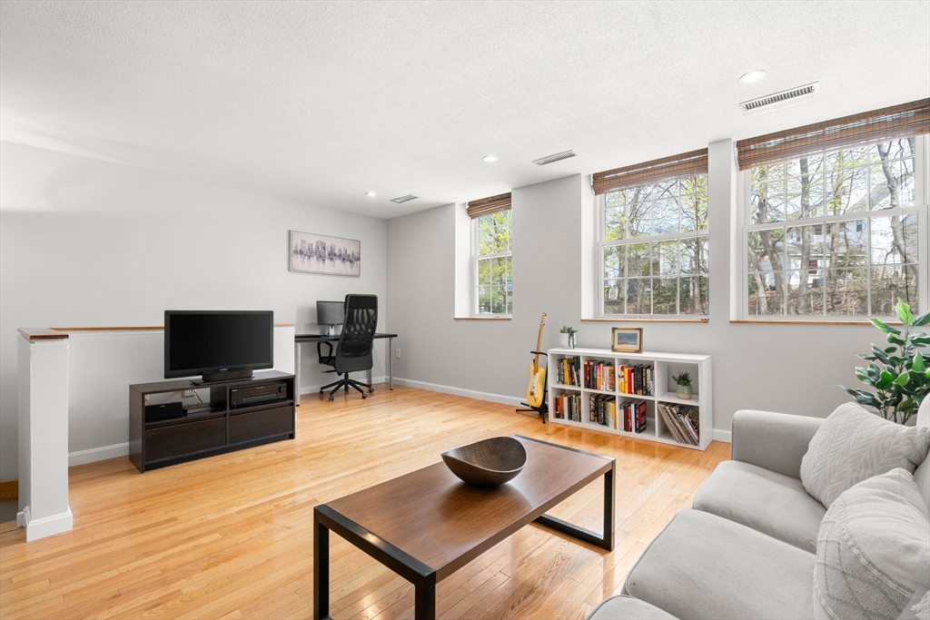35 Eldridge Road, Unit 202 Boston, MA 02130 - Photo 4 of 31 a living room with furniture and a flat screen tv