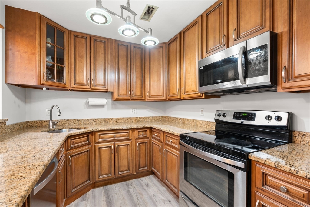 35 Eldridge Road, Unit 202 Boston, MA 02130 - Photo 9 of 31 a kitchen with stainless steel appliances granite countertop a sink and a stove
