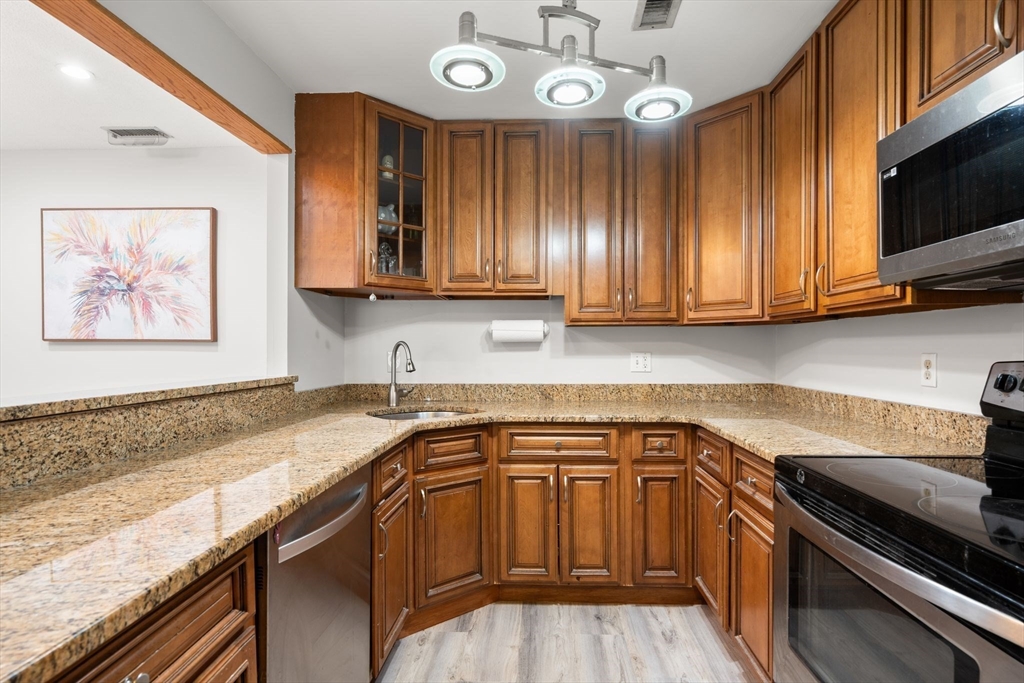 35 Eldridge Road, Unit 202 Boston, MA 02130 - Photo 10 of 31 a kitchen with granite countertop a sink stainless steel appliances and cabinets