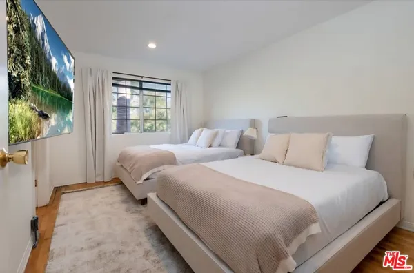 a bedroom with a bed and a painting on the wall