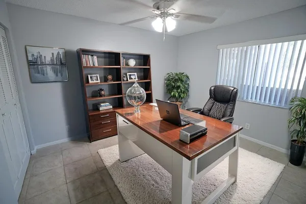 a living room with furniture a rug and a window