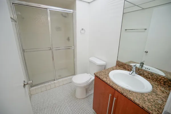 a bathroom with a sink toilet and shower