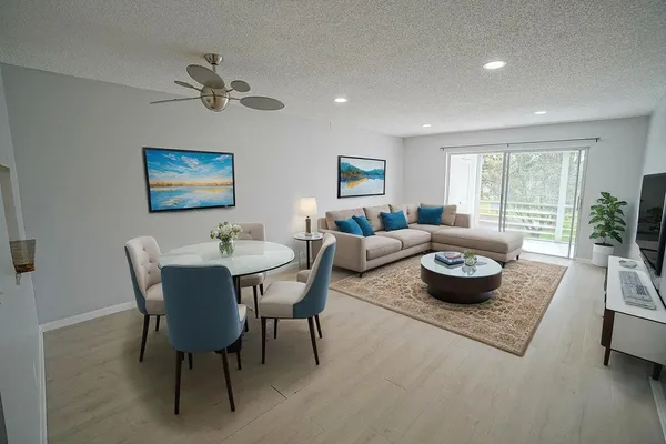 a living room with furniture and a potted plant
