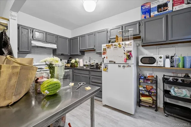 a kitchen with stainless steel appliances a stove a refrigerator and a sink