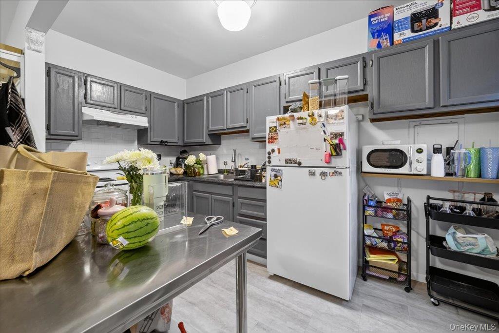 89 Liberty Street Newburgh, NY 12550 - Photo 16 of 33 a kitchen with stainless steel appliances a stove a refrigerator and a sink