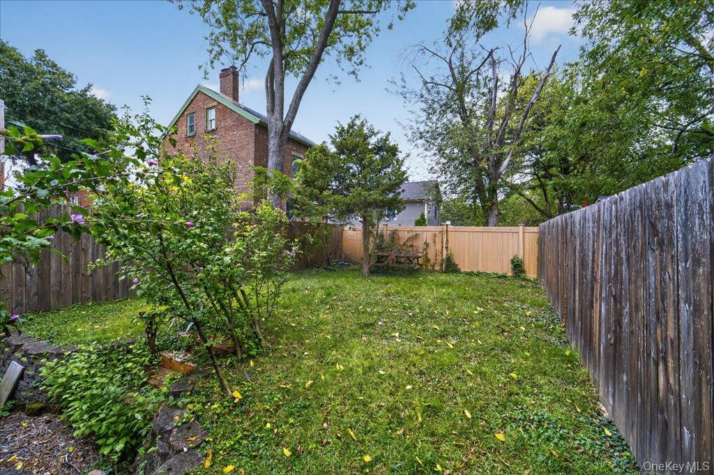 89 Liberty Street Newburgh, NY 12550 - Photo 28 of 33 a view of a backyard with plants and large trees