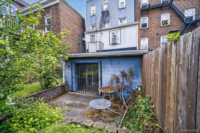 a front view of a house with a garden and plants
