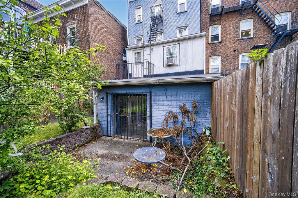 89 Liberty Street Newburgh, NY 12550 - Photo 29 of 33 a front view of a house with a garden and plants