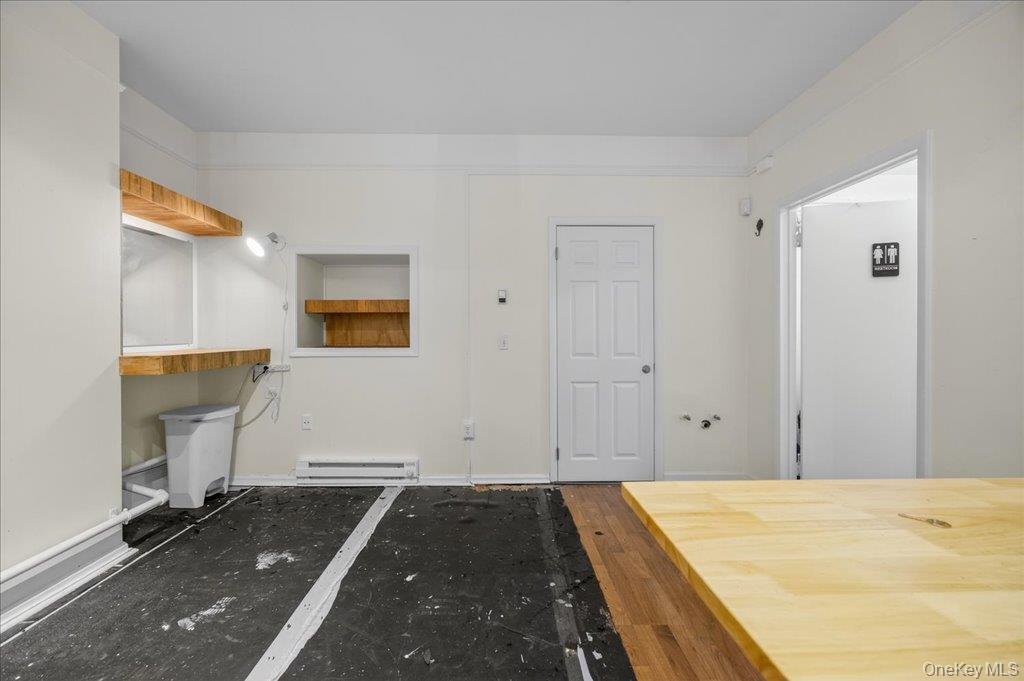 89 Liberty Street Newburgh, NY 12550 - Photo 7 of 33 a spacious bedroom with a bed and a table