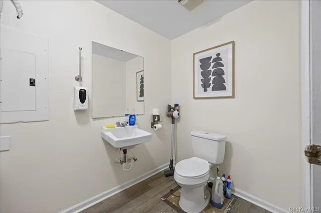 a bathroom with a toilet a sink and mirror