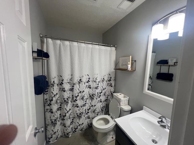 2938 Simmons Road Drummonds, TN 38023 - Photo 6 of 13 Bathroom featuring vanity, curtained shower, and a textured ceiling