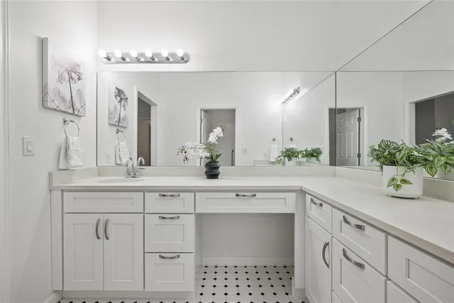 a spacious bathroom with a sink and a mirror